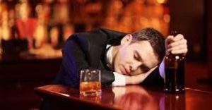 man with head on bar drunk