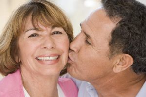 man kissing woman