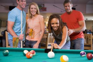 playing billiards with a pint of beer
